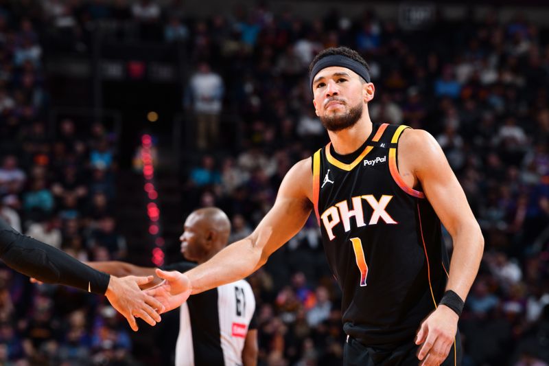 PHOENIX, AZ - DECEMBER 3: Devin Booker #1 of the Phoenix Suns high fives teammate during the game against the San Antonio Spurs during a Emirates NBA Cup game on December 3, 2024 at Footprint Center in Phoenix, Arizona. NOTE TO USER: User expressly acknowledges and agrees that, by downloading and or using this photograph, user is consenting to the terms and conditions of the Getty Images License Agreement. Mandatory Copyright Notice: Copyright 2024 NBAE (Photo by Barry Gossage/NBAE via Getty Images)