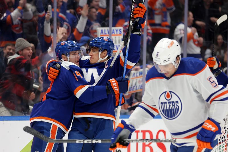 Dec 19, 2023; Elmont, New York, USA; New York Islanders left wing Anders Lee (27) celebrates his power play goal against the Edmonton Oilers with center Bo Horvat (14) during the second period at UBS Arena. Mandatory Credit: Brad Penner-USA TODAY Sports