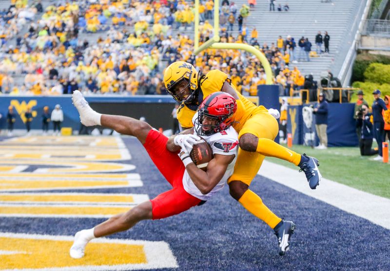 Sep 23, 2023; Morgantown, West Virginia, USA; Texas Tech Red Raiders wide receiver Jerand Bradley (9) catches a pass for a touchdown against West Virginia Mountaineers cornerback Malachi Ruffin (14) during the fourth quarter at Mountaineer Field at Milan Puskar Stadium. Mandatory Credit: Ben Queen-USA TODAY Sports