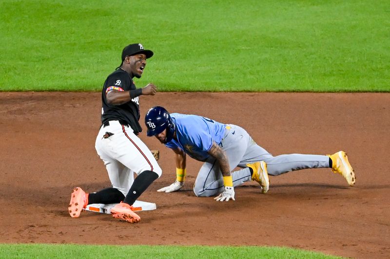 May 31, 2024; Baltimore, Maryland, USA;  Baltimore Orioles second basema Jorge Mateo (3) reacts as Tampa Bay Rays outfielder Jose Siri (22) is called out stealing ht esixth inning at Oriole Park at Camden Yards. Mandatory Credit: Tommy Gilligan-USA TODAY Sports