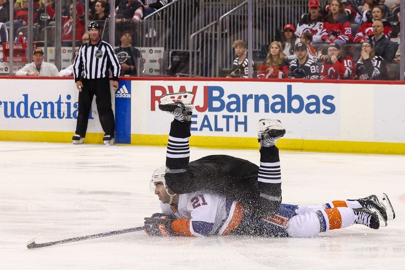 Apr 15, 2024; Newark, New Jersey, USA; New York Islanders center Kyle Palmieri (21) and New Jersey Devils defenseman Luke Hughes (43) collide during the third period at Prudential Center. Mandatory Credit: Ed Mulholland-USA TODAY Sports