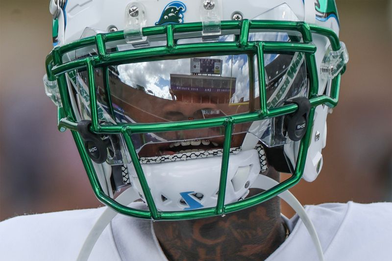 Oct 28, 2023; Houston, Texas, USA; The facemark of Tulane Green Wave wide receiver Jalen Rogers (85) reflects the Rice Stadium score board as he warms up before playing against the Rice Owls. Mandatory Credit: Thomas Shea-USA TODAY Sports