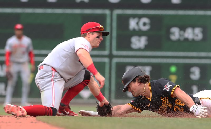 May 21, 2025; Pittsburgh, Pennsylvania, USA;  Cincinnati Reds second baseman Matt McLain (9) tags Pittsburgh Pirates second baseman Adam Frazier (26) out at second base on a steal attempt during the eighth inning at PNC Park. Mandatory Credit: Charles LeClaire-Imagn Images