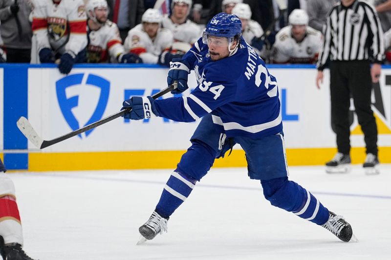 May 5, 2025; Toronto, Ontario, CAN; Toronto Maple Leafs forward Auston Matthews (34) shoots against the Florida Panthers during the third period of the second round of the 2025 Stanley Cup Playoffs at Scotiabank Arena. Mandatory Credit: John E. Sokolowski-Imagn Images