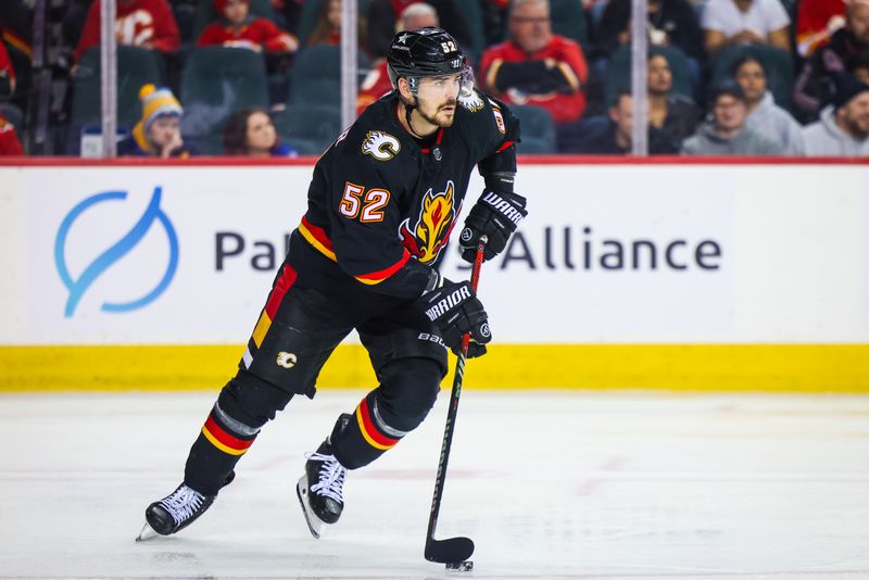 Jan 23, 2024; Calgary, Alberta, CAN; Calgary Flames defenseman MacKenzie Weegar (52) controls the puck against the St. Louis Blues during the third period at Scotiabank Saddledome. Mandatory Credit: Sergei Belski-USA TODAY Sports