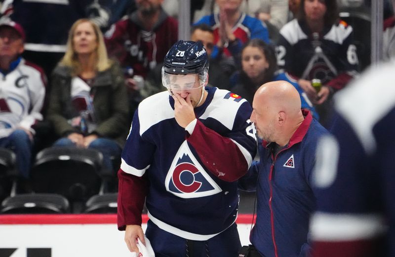 Dec 7, 2023; Denver, Colorado, USA; Colorado Avalanche left wing Miles Wood (28) is helped off the ice in the third period against the Winnipeg Jets at Ball Arena. Mandatory Credit: Ron Chenoy-USA TODAY Sports