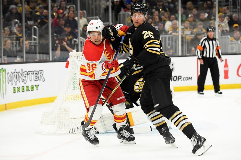 Feb 6, 2024; Boston, Massachusetts, USA; Andrei Kuzmenko Left wing (96) and Boston Bruins defenseman Brandon Carlo (25) battle for position during the second period at TD Garden. Mandatory Credit: Bob DeChiara-USA TODAY Sports