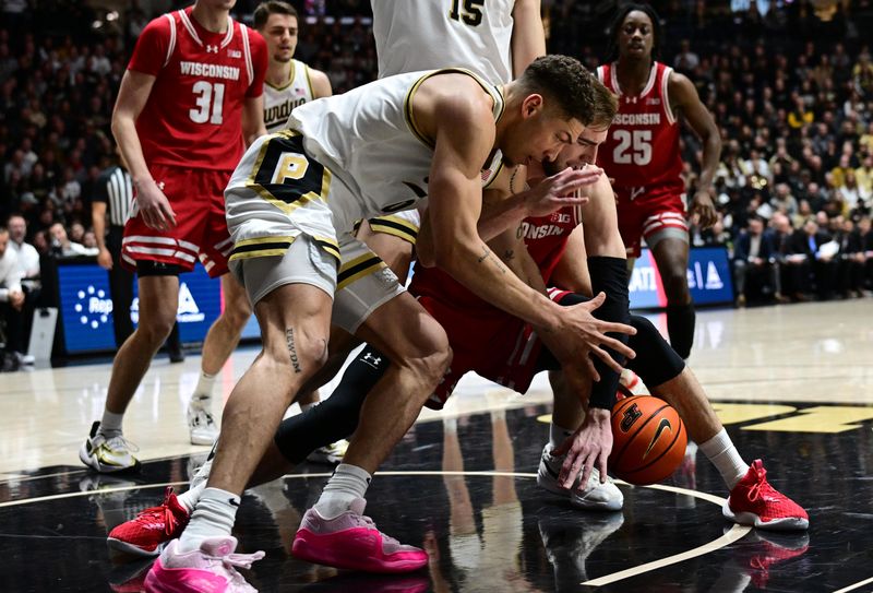 Mar 10, 2024; West Lafayette, Indiana, USA; Purdue Boilermakers forward Mason Gillis (0) and Wisconsin Badgers forward Tyler Wahl (5) go after a loose ball during the first half at Mackey Arena. Mandatory Credit: Marc Lebryk-USA TODAY Sports