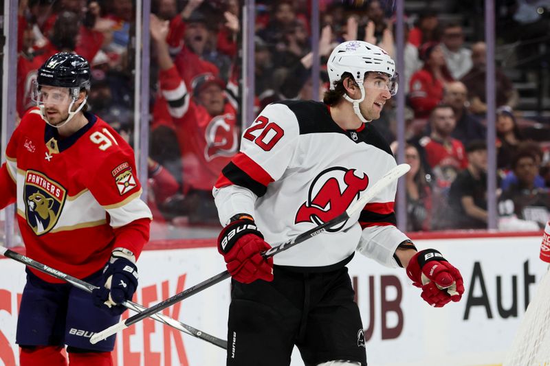 Jan 13, 2024; Sunrise, Florida, USA; New Jersey Devils center Michael McLeod (20) looks on after a goal by left wing Jesper Bratt (not pictured) against the Florida Panthers during the first period at Amerant Bank Arena. Mandatory Credit: Sam Navarro-USA TODAY Sports