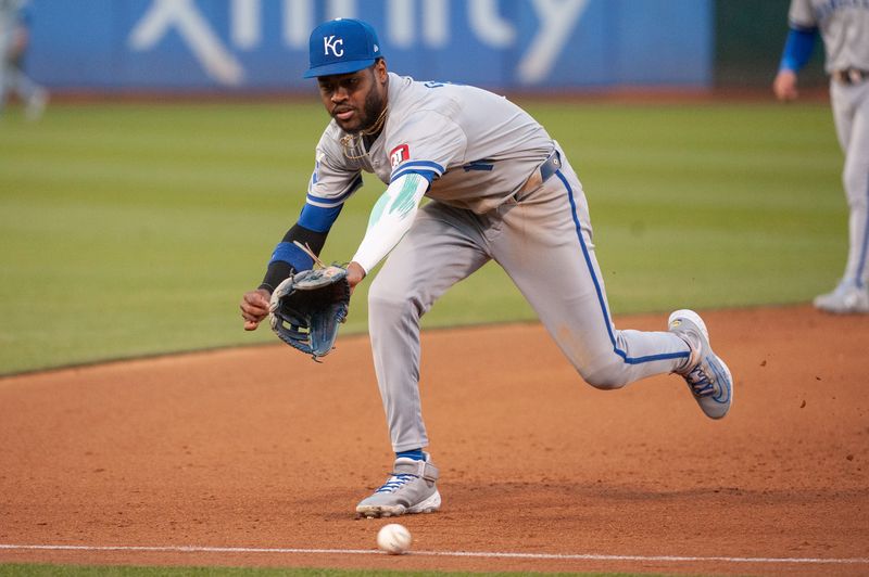 Jun 18, 2024; Oakland, California, USA; Kansas City Royals third base Maikel Garcia (11) is unable to make a play on the ball during the fourth inning against the Oakland Athletics at Oakland-Alameda County Coliseum. Mandatory Credit: Ed Szczepanski-USA TODAY Sports