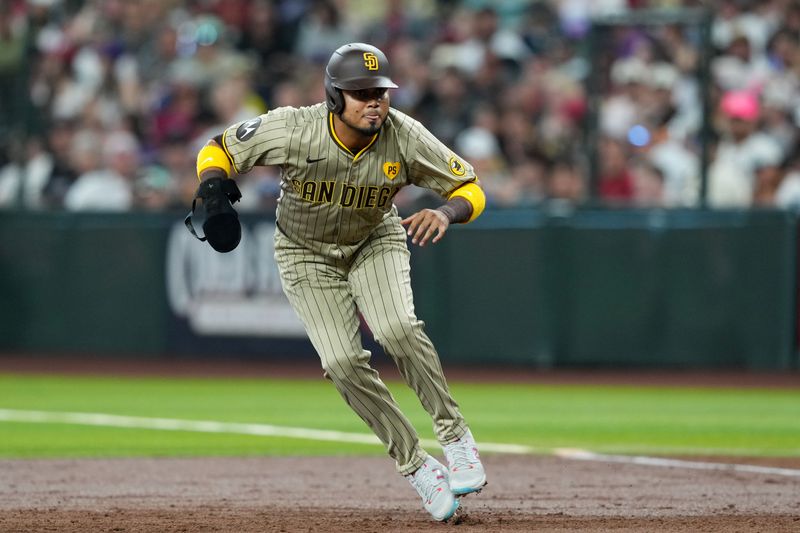 May 4, 2024; Phoenix, Arizona, USA; San Diego Padres designated hitter Luis Arraez (4) leads off first base against the Arizona Diamondbacks during the third inning at Chase Field. Mandatory Credit: Joe Camporeale-USA TODAY Sports