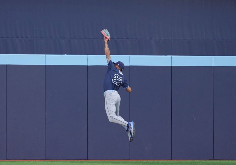 Jul 23, 2024; Toronto, Ontario, CAN; Tampa Bay Rays center fielder Jose Siri (22) catches a fly ball against the Toronto Blue Jays during the second inning at Rogers Centre. Mandatory Credit: Nick Turchiaro-USA TODAY Sports