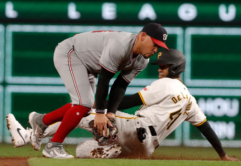 Sep 5, 2024; Pittsburgh, Pennsylvania, USA;  Pittsburgh Pirates pinch hitter Bryan De La Cruz (right) steals second base as Washington Nationals second baseman Ildemaro Vargas (left)attempts to make the tag during the sixth inning at PNC Park. Mandatory Credit: Charles LeClaire-Imagn Images