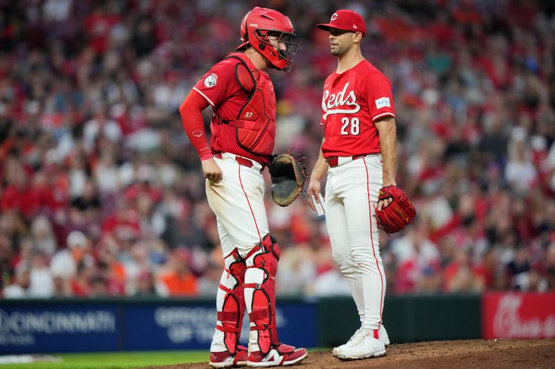 May 5, 2024; Cincinnati, Ohio, USA; Cincinnati Reds catcher Tyler Stephenson (37) visits pitcher Nick Martinez (28) at the mound in the sixth inning against the Baltimore Orioles at Great American Ball Park in Cincinnati. Mandatory Credit: Kareem Elgazzar-USA TODAY Sports