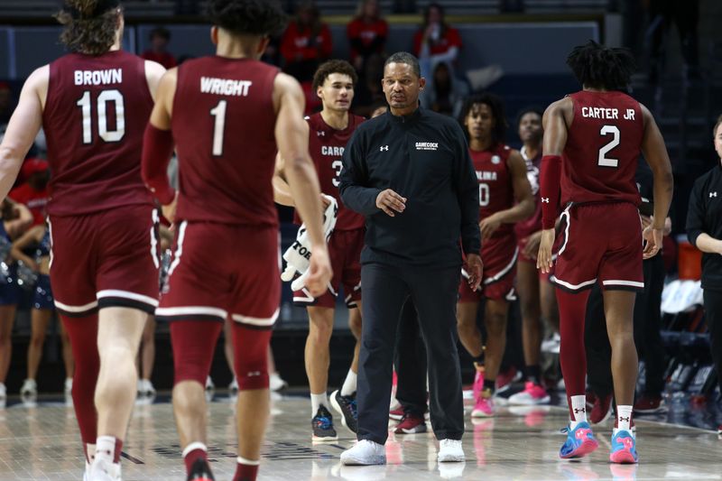 Feb 11, 2023; Oxford, Mississippi, USA; South Carolina Gamecocks head coach Lamont Paris reacts with forward Hayden Brown (10) and guard Jacobi Wright (1) during a timeout during the second half at The Sandy and John Black Pavilion at Ole Miss. Mandatory Credit: Petre Thomas-USA TODAY Sports