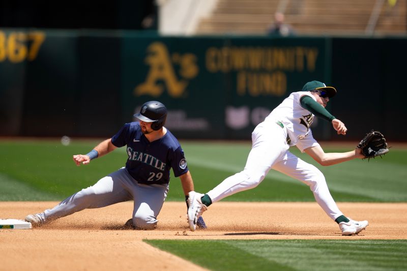 Jun 6, 2024; Oakland, California, USA; Seattle Mariners catcher Cal Raleigh (29) slides safely into second base with a steal as Oakland Athletics second baseman Zack Gelof (20) awaits the late throw during the fourth inning at Oakland-Alameda County Coliseum. Mandatory Credit: D. Ross Cameron-USA TODAY Sports