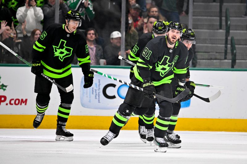 Nov 29, 2024; Dallas, Texas, USA; Dallas Stars defenseman Thomas Harley (55) and center Tyler Seguin (91) and right wing Evgenii Dadonov (63) and left wing Mason Marchment (27) celebrate a power play goal scored by Seguin against the Colorado Avalanche during the first period at the American Airlines Center. Mandatory Credit: Jerome Miron-Imagn Images