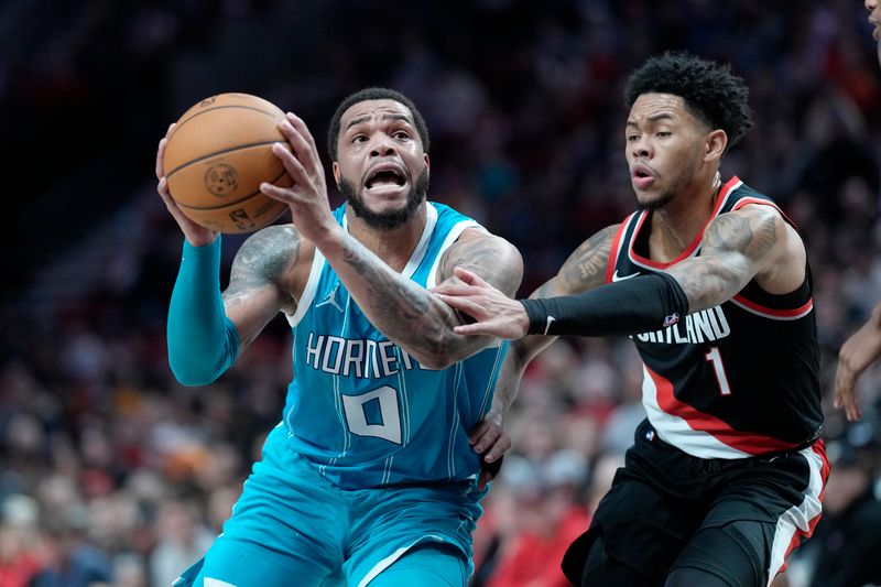 PORTLAND, OREGON - FEBRUARY 25: Miles Bridges #0 of the Charlotte Hornets drives to the basket against Anfernee Simons #1 of the Portland Trail Blazers during the first half at Moda Center on February 25, 2024 in Portland, Oregon. NOTE TO USER: User expressly acknowledges and agrees that, by downloading and or using this photograph, User is consenting to the terms and conditions of the Getty Images License Agreement. (Photo by Soobum Im/Getty Images)