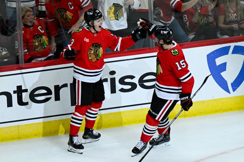 Oct 19, 2024; Chicago, Illinois, USA;  Chicago Blackhawks left wing Lukas Reichel (73) celebrates after assisting  center Craig Smith (15) with a goal during the second period against the Buffalo Sabres at the United Center. Mandatory Credit: Matt Marton-Imagn Images