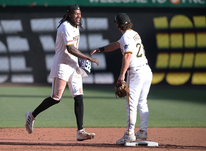 May 24, 2025; Pittsburgh, Pennsylvania, USA;  Pittsburgh Pirates center fielder Oneil Cruz (left) and second baseman Adam Frazier (26) celebrate after defeating the Milwaukee Brewers at PNC Park. Mandatory Credit: Charles LeClaire-Imagn Images