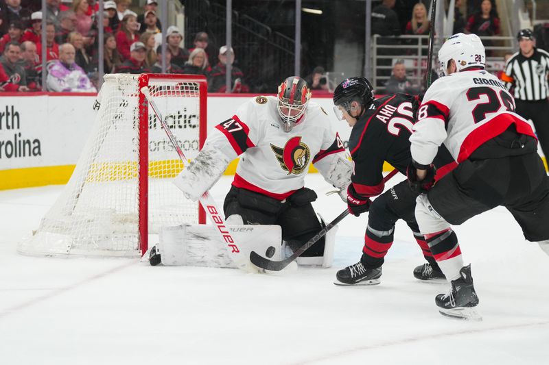 Feb 3, 2026; Raleigh, North Carolina, USA;  Ottawa Senators goaltender James Reimer (47) stops the shot by Carolina Hurricanes center Sebastian Aho (20) during the first period at Lenovo Center. Mandatory Credit: James Guillory-Imagn Images
