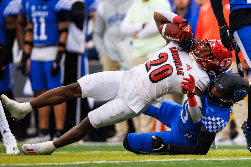 Nov 26, 2022; Lexington, Kentucky, USA; Louisville Cardinals running back Maurice Turner (20) is tackled by Kentucky Wildcats defensive back Jordan Lovett (25) during the first quarter at Kroger Field. Mandatory Credit: Jordan Prather-USA TODAY Sports