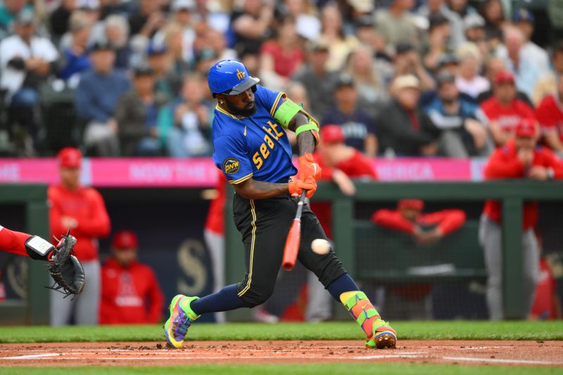 Sep 11, 2025; Seattle, Washington, USA; Seattle Mariners left fielder Randy Arozarena (56) hits a single against the Los Angeles Angels during the first inning at T-Mobile Park. Mandatory Credit: Steven Bisig-Imagn Images