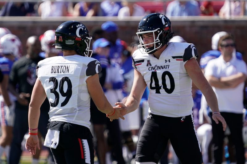 Oct 22, 2022; Dallas, Texas, USA; Cincinnati Bearcats place kicker Ryan Coe (40) and holder Bryce Burton (39) celebrate  a 31-yard field goal, one of his five field goals during the game against the Southern Methodist Mustangs at Gerald J. Ford Stadium. Mandatory Credit: Raymond Carlin III-USA TODAY Sports