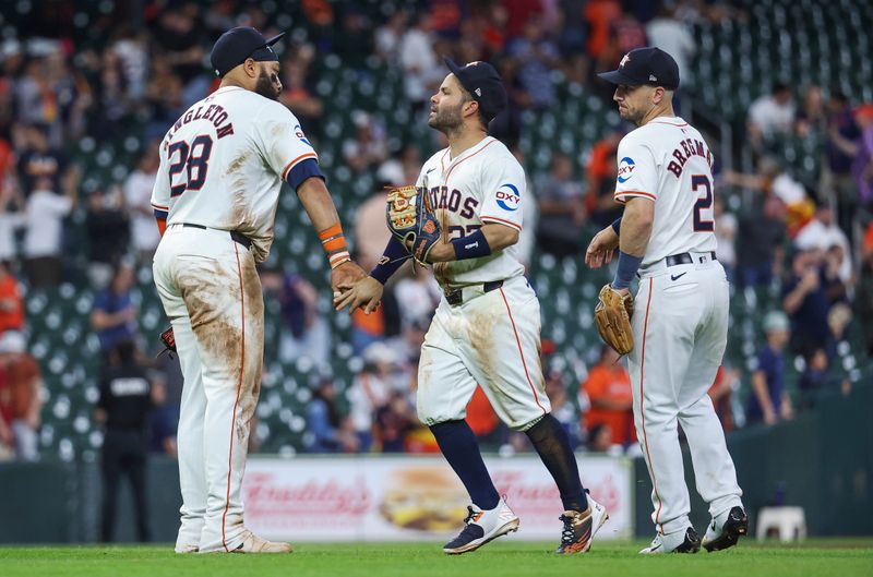 May 2, 2024; Houston, Texas, USA; Houston Astros first baseman Jon Singleton (28) celebrates with second baseman Jose Altuve (27) after the game against the Cleveland Guardians at Minute Maid Park. Mandatory Credit: Troy Taormina-USA TODAY Sports