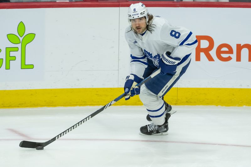 Jan 25, 2025; Ottawa, Ontario, CAN; Toronto Maple Leafs deenseman Christopher Tanev (8) skates with the puck against the Ottawa Senators in the third period at the Canadian Tire Centre. Mandatory Credit: Marc DesRosiers-Imagn Images