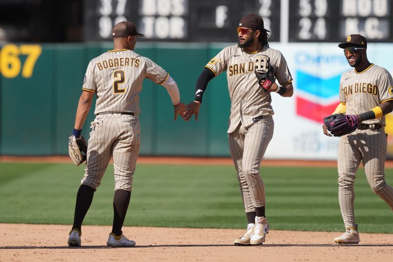 Sep 17, 2023; Oakland, California, USA; San Diego Padres right fielder Fernando Tatis Jr. (second from right) celebrates with shortstop Xander Bogaerts (2) after defeating the Oakland Athletics at Oakland-Alameda County Coliseum. Mandatory Credit: Darren Yamashita-USA TODAY Sports