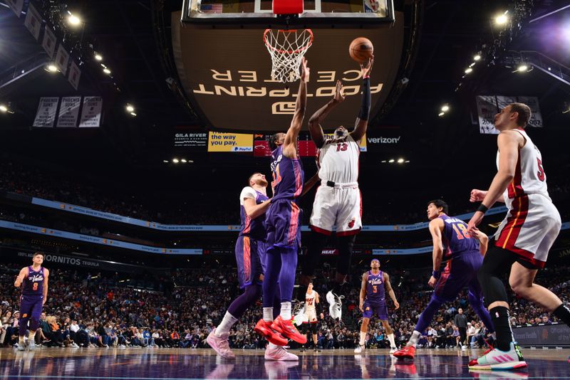 PHOENIX, AZ - JANUARY 5: Bam Adebayo #13 of the Miami Heat drives to the basket during the game against the Phoenix Suns on January 5, 2023 at Footprint Center in Phoenix, Arizona. NOTE TO USER: User expressly acknowledges and agrees that, by downloading and or using this photograph, user is consenting to the terms and conditions of the Getty Images License Agreement. Mandatory Copyright Notice: Copyright 2024 NBAE (Photo by Barry Gossage/NBAE via Getty Images)