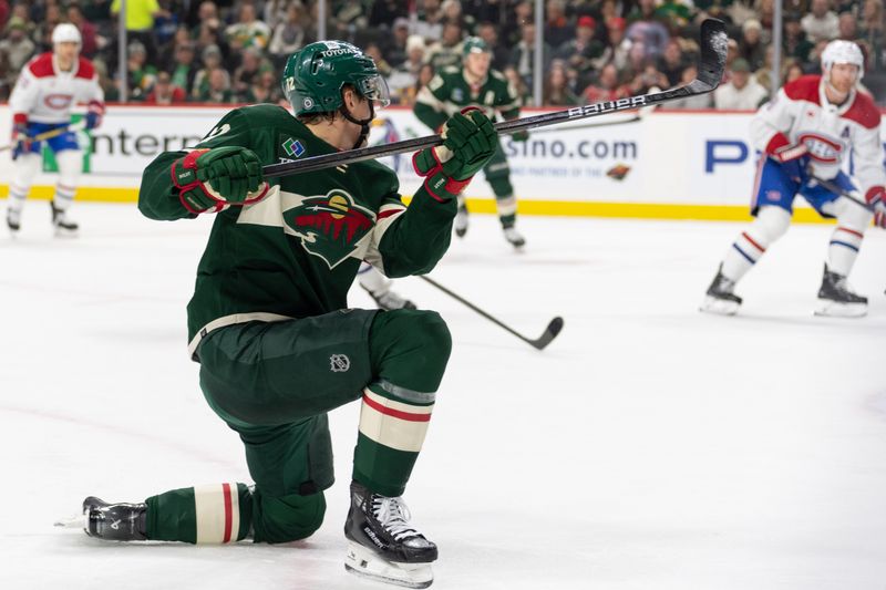 Dec 21, 2023; Saint Paul, Minnesota, USA; Minnesota Wild left wing Matt Boldy (12) scores against the Montreal Canadiens in the first period at Xcel Energy Center. Mandatory Credit: Matt Blewett-USA TODAY Sports