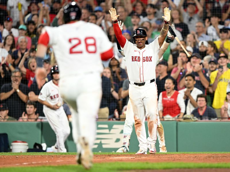 Aug 14, 2024; Boston, Massachusetts, USA; Boston Red Sox third base Rafael Devers (11) reacts as catcher Danny Jansen (28) runs into home after a two-run RBI double was hit by first base Romy Gonzalez (not seen) during the eighth inning at Fenway Park. Mandatory Credit: Brian Fluharty-USA TODAY Sports