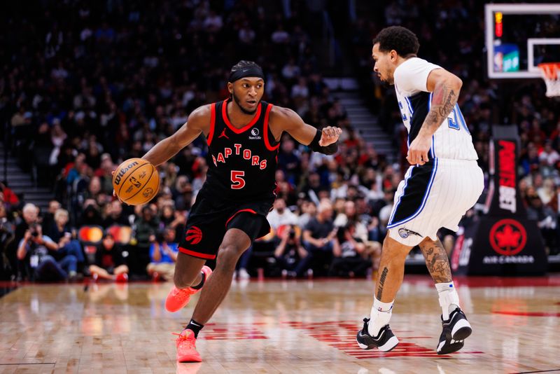 TORONTO, CANADA - JANUARY 03: Immanuel Quickley #5 of the Toronto Raptors dribbles the ball against Cole Anthony #50 of the Orlando Magic during second half of their NBA game at Scotiabank Arena on January 3, 2025 in Toronto, Canada. NOTE TO USER: User expressly acknowledges and agrees that, by downloading and or using this photograph, User is consenting to the terms and conditions of the Getty Images License Agreement. (Photo by Cole Burston/Getty Images)