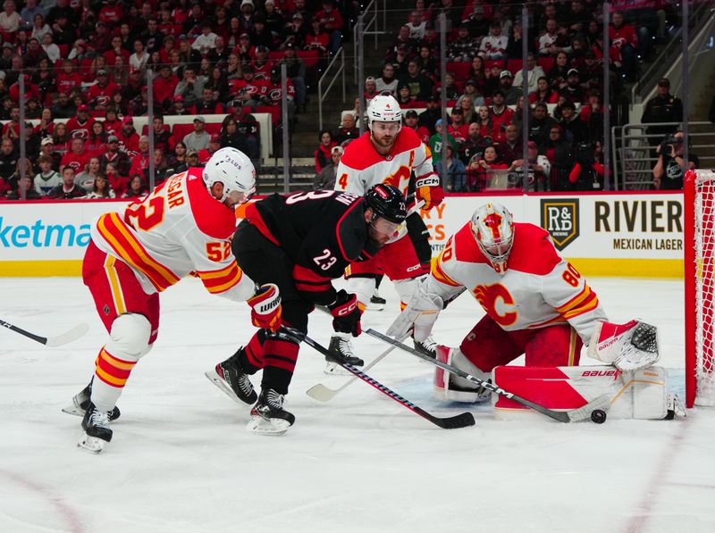 Mar 10, 2024; Raleigh, North Carolina, USA;  Carolina Hurricanes right wing Stefan Noesen (23) scoring attempt is stopped by Calgary Flames goaltender Dan Vladar (80) and defenseman MacKenzie Weegar (52) during the first period at PNC Arena. Mandatory Credit: James Guillory-USA TODAY Sports