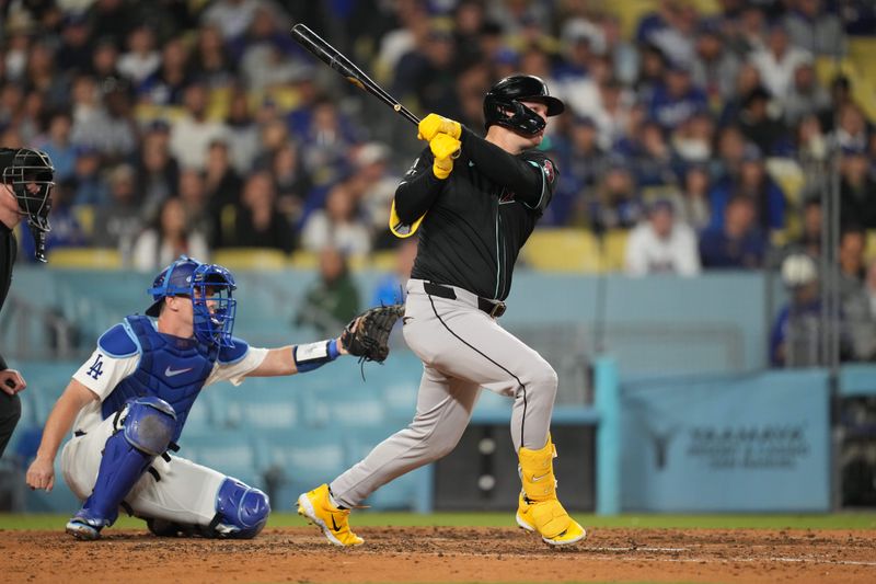 May 21, 2024; Los Angeles, California, USA; Arizona Diamondbacks designated hitter Joc Pederson (3) hits a three-run home run in the seventh inning as Los Angeles Dodgers catcher Will Smith (16) watches at Dodger Stadium. Mandatory Credit: Kirby Lee-USA TODAY Sports