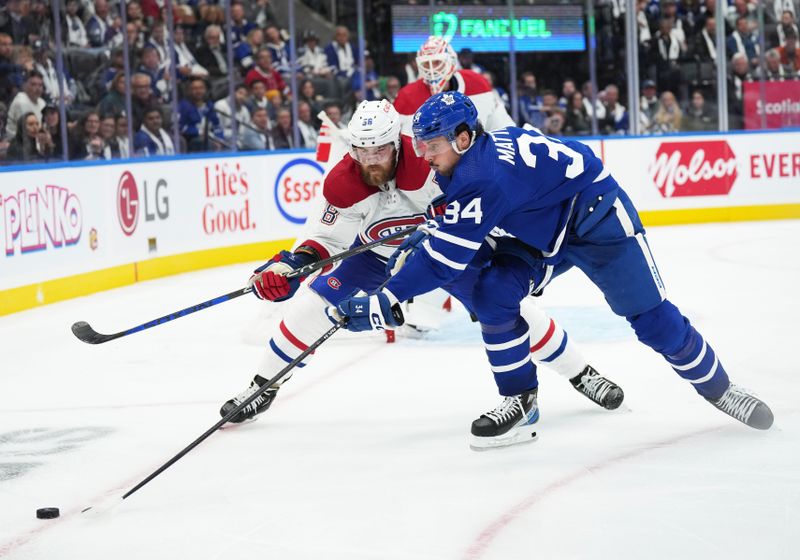 Oct 11, 2023; Toronto, Ontario, CAN; Toronto Maple Leafs center Auston Matthews (34) battles for the puck with Montreal Canadiens defenseman David Savard (58) during the third period at Scotiabank Arena. Mandatory Credit: Nick Turchiaro-USA TODAY Sports