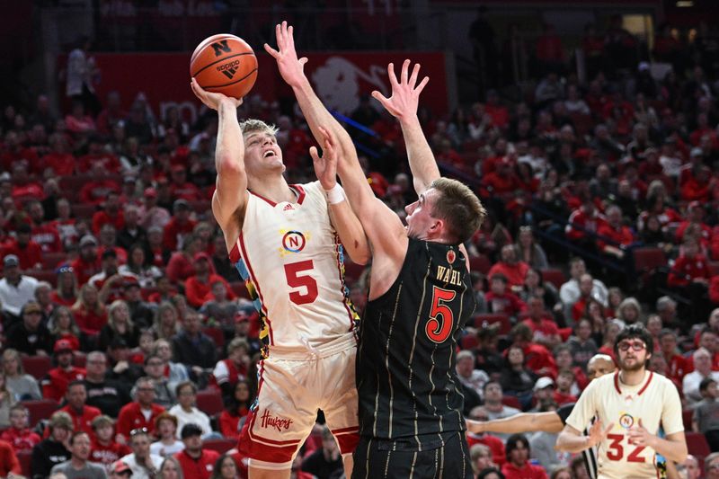 Feb 11, 2023; Lincoln, Nebraska, USA;  Nebraska Cornhuskers guard Sam Griesel (5) scores over Wisconsin Badgers forward Tyler Wahl (5) in the first half at Pinnacle Bank Arena. Mandatory Credit: Steven Branscombe-USA TODAY Sports