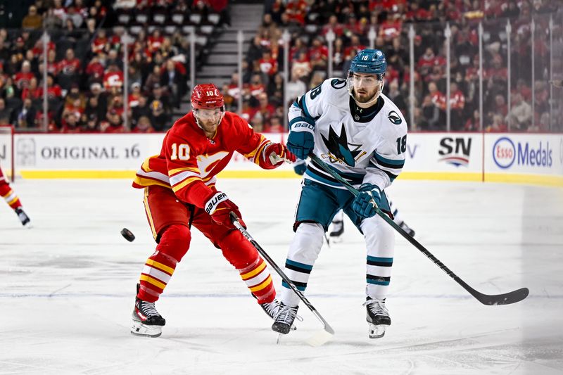 Feb 15, 2024; Calgary, Alberta, CAN; Calgary Flames center Jonathan Huberdeau (10) and San Jose Sharks right wing Filip Zadina (18) in action during the first period at Scotiabank Saddledome. Mandatory Credit: Brett Holmes-USA TODAY Sports