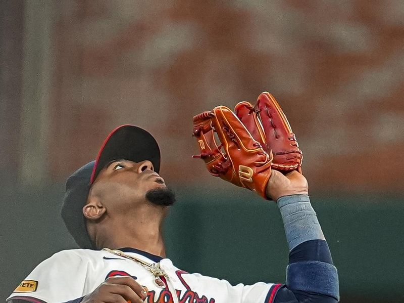 May 14, 2024; Cumberland, Georgia, USA; Atlanta Braves second baseman Ozzie Albies (1) catches a pop up hit by Chicago Cubs right fielder Mike Tauchman (40) (not shown) during the ninth inning at Truist Park. Mandatory Credit: Dale Zanine-USA TODAY Sports