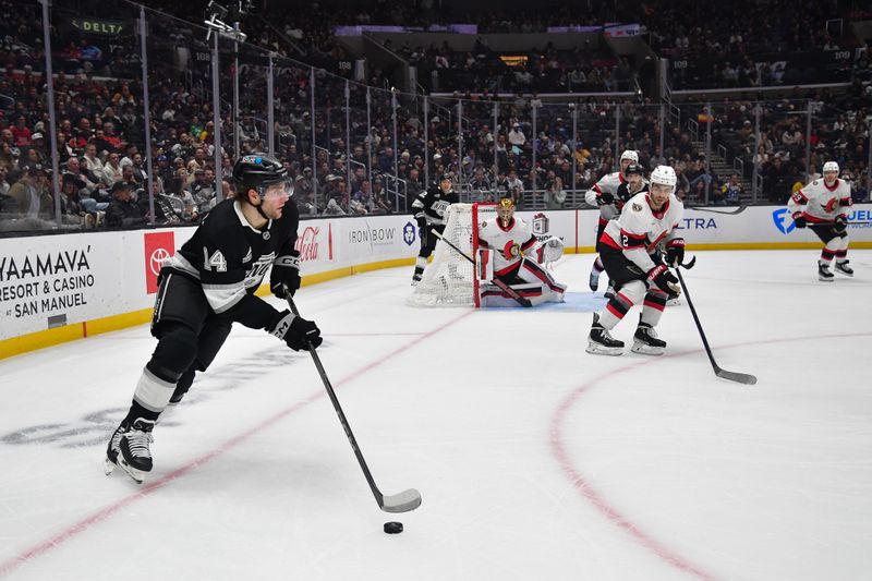 Nov 24, 2025; Los Angeles, California, USA; Los Angeles Kings right wing Alex Laferriere (14) moves the puck against the Ottawa Senators during the second period at Crypto.com Arena. Mandatory Credit: Gary A. Vasquez-Imagn Images