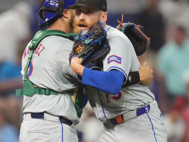 May 19, 2024; Miami, Florida, USA;  New York Mets catcher Omar Narváez (2) congratulates relief pitcher Reed Garrett (75) following a victory over the Miami Marlins at loanDepot Park. Mandatory Credit: Jim Rassol-USA TODAY Sports