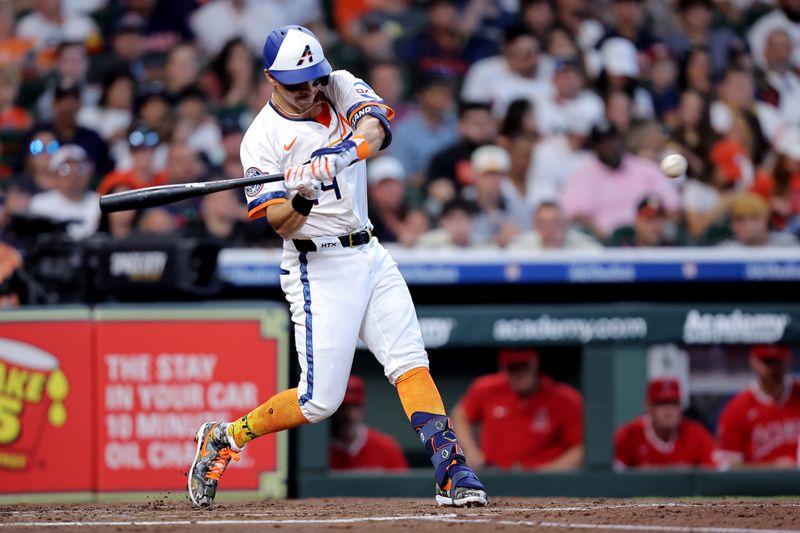 Apr 13, 2025; Houston, Texas, USA; Houston Astros second baseman Mauricio Dubon (14) hits an RBI double against the Los Angeles Angels during the second inning at Daikin Park. Mandatory Credit: Erik Williams-Imagn Images