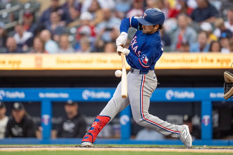 May 24, 2024; Minneapolis, Minnesota, USA; Texas Rangers third base Josh Smith (8) connects against Minnesota Twins pitcher Bailey Ober (17) in the first inning at Target Field. Mandatory Credit: Matt Blewett-USA TODAY Sports