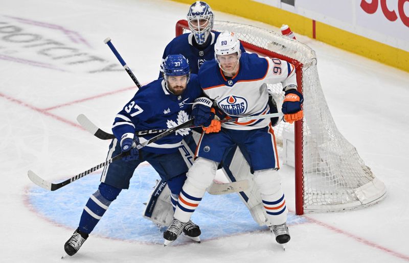 Mar 23, 2024; Toronto, Ontario, CAN; Toronto Maple Leafs defenseman Timothy Liljegren (37) covers Edmonton Oilers forward Corey Perry (90) in front of goalie Ilya Samsonov (35) in the third period at Scotiabank Arena. Mandatory Credit: Dan Hamilton-USA TODAY Sports