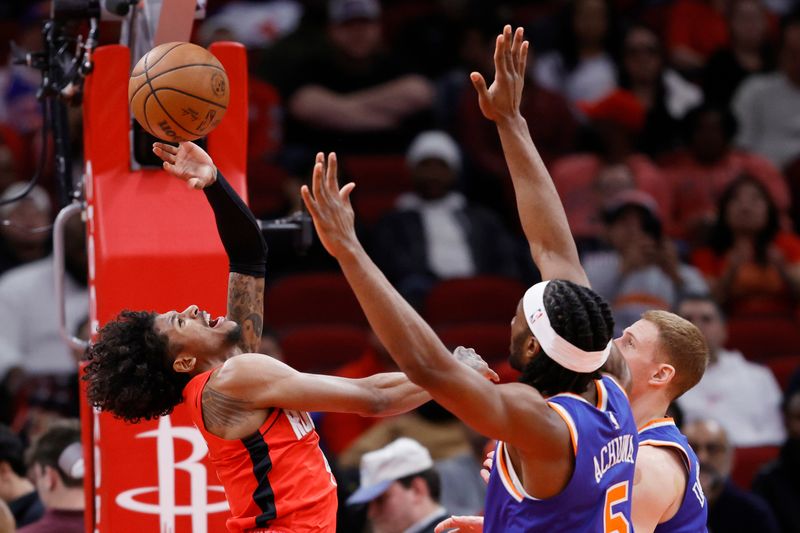 HOUSTON, TEXAS - FEBRUARY 12: Jalen Green #4 of the Houston Rockets is fouled on a play by Precious Achiuwa #5 of the New York Knicks during the first half at Toyota Center on February 12, 2024 in Houston, Texas. NOTE TO USER: User expressly acknowledges and agrees that, by downloading and or using this photograph, User is consenting to the terms and conditions of the Getty Images License Agreement. (Photo by Carmen Mandato/Getty Images)