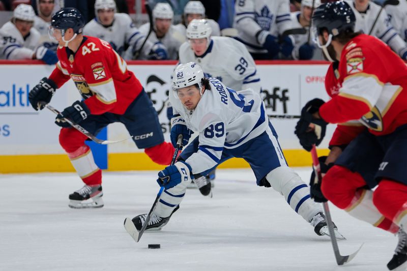 Nov 27, 2024; Sunrise, Florida, USA; Toronto Maple Leafs left wing Nicholas Robertson (89) moves the puck against the Florida Panthers during the second period at Amerant Bank Arena. Mandatory Credit: Sam Navarro-Imagn Images