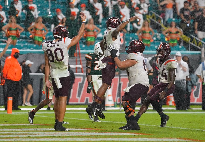 Nov 20, 2021; Miami Gardens, Florida, USA; Virginia Tech Hokies wide receiver Da'Wain Lofton (18) celebrates his touchdown against the Miami Hurricanes with teammates on the field during the second half at Hard Rock Stadium. Mandatory Credit: Jasen Vinlove-USA TODAY Sports