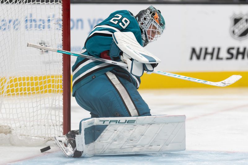 Nov 2, 2023; San Jose, California, USA; The puck passes by San Jose Sharks goaltender Mackenzie Blackwood (29) during the third period against the Vancouver Canucks at SAP Center at San Jose. Mandatory Credit: Stan Szeto-USA TODAY Sports